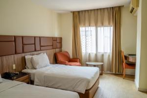 Postel nebo postele na pokoji v ubytování Hotel Alia Cikini