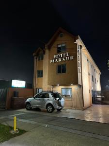 a car parked in front of a hotel marriot at Hotel Mar Sur in Talcahuano