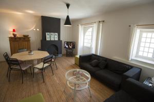 a living room with a couch and a table at Clos Normand in Nieuwpoort