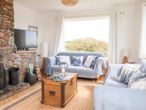a living room with a couch and a fireplace at Cerrig in Holyhead