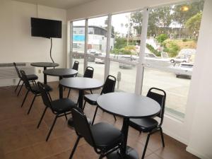 a meeting room with tables and chairs and a window at Beachview Inn in Santa Cruz