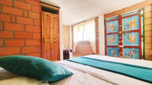 Postel nebo postele na pokoji v ubytování Hostal Vista Hermosa