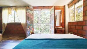 Postel nebo postele na pokoji v ubytování Hostal Vista Hermosa