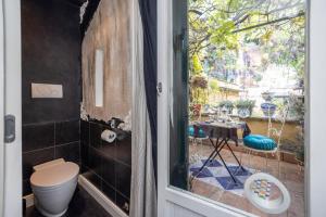a bathroom with a toilet and a window at Margutta 46 private spa in Rome