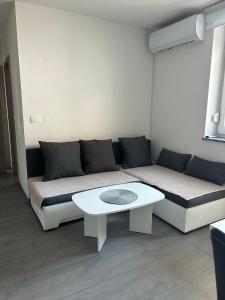a living room with a couch and a table at Perfect Place for two in Kranj