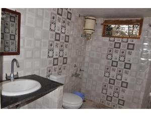 a bathroom with a sink and a toilet at Rekha & Kamla Homestay, Orchha 
