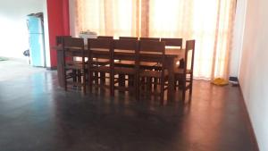 a wooden table and chairs in a room at Forest Edge Bungalow - Wilpattu in Radagama