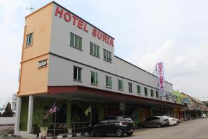 a hotel with cars parked in front of it at JQ Suria Hotel in Lahat