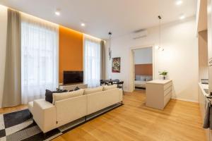 a living room with a couch and a television at Luxurious Minimalist Residence with Sauna by Prestige Homes in Budapest