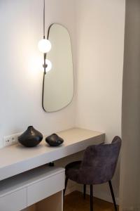 a room with a desk with a mirror and a chair at Luxurious Minimalist Residence with Sauna by Prestige Homes in Budapest