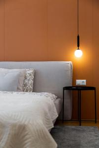 a bedroom with a bed and a table with a lamp at Luxurious Minimalist Residence with Sauna by Prestige Homes in Budapest