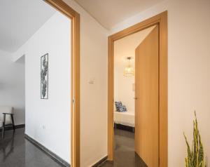 a hallway with a door leading to a bedroom at Macflats Ciudad de las Ciencias in Valencia