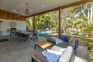 a living room with a couch and a table at Lazuli in Blueys Beach