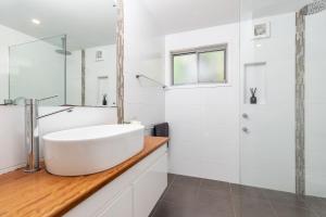 a white bathroom with a sink and a shower at Lazuli in Blueys Beach +23 photos