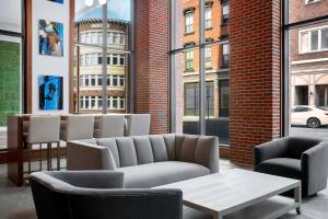 a lobby with a couch and chairs and a table at Residence Inn by Marriott Norwalk in Norwalk