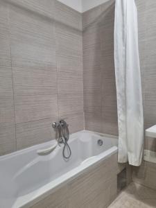 a bathroom with a bath tub with a shower curtain at Apartman Niko in Zagreb