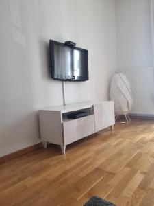 a living room with a flat screen tv on a wall at Apartman Niko in Zagreb