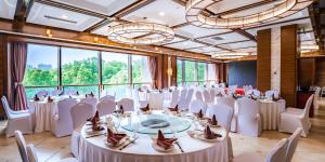 a banquet hall with white tables and chairs and large windows at Holiday Inn Changzhou Wujin by IHG in Changzhou +153 photos
