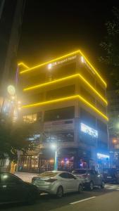 a building with cars parked in front of it at night at DK Incheon airport hotel in Incheon