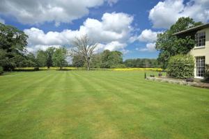 a large lawn with a tree in the middle at Congham Hall Hotel & Spa in Grimston