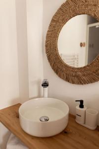 a bathroom with a white sink and a mirror at Men Louet O - Gîte de bord de mer in Ploudalmézeau