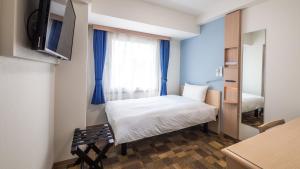 Postel nebo postele na pokoji v ubytování Toyoko Inn Chigasaki Shiyakusho