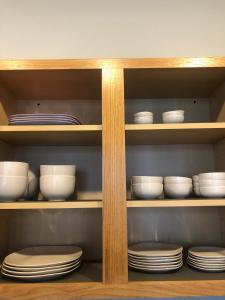 a shelf with plates and bowls in a kitchen at Winter Wonderland Retreat and Your Chicago Chill Getaway in Chicago
