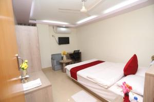 a hospital room with a bed and a tv at Wood Burn Hotel in Bogra