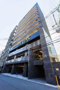 a building with a sign on the side of it at Apartment Hotel 11 Umeda in Osaka