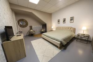a bedroom with a bed and a flat screen tv at Loft 250m2 avec écran led géant de 10m2 in Marseille