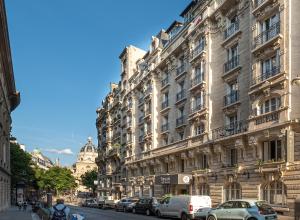 a large building with cars parked in front of it at Hotel Trianon Rive Gauche in Paris +119 photos