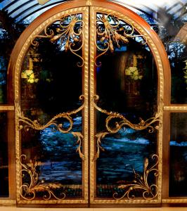an ornate glass door with a painting on it at Seibel's Park Hotel in Munich