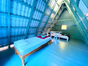 a room with a bed and a table in it at Falling Water Resort by Travent Mug in Sakleshpur