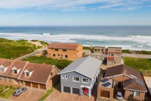 an aerial view of a house and the ocean at Jolie Beach Apartment in Wilderness