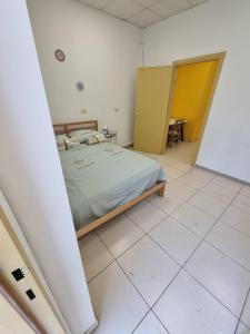 a bedroom with a bed and a yellow door at Fellini 8 1/2 in Haifa