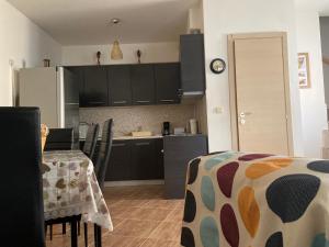 a kitchen with black cabinets and a table with chairs at Villa Armonia in Skala Potamias