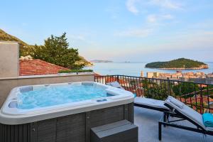 a hot tub on a balcony with a view of the ocean at New & Stunning Views in Luxury 5* Divona Apartment in Dubrovnik