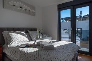 een slaapkamer met een wit bed en een raam bij Apartment Dalmo Views in Zadar