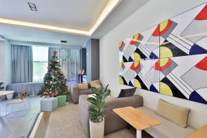 a living room with a christmas tree and a couch at Brown Dot Hotel Ulsan Samsan in Ulsan