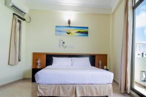Postel nebo postele na pokoji v ubytování Maaniya Residence