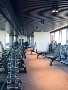 a gym with a row of treadmills and benches at Anthem Stylish 1BR Apartment - with top amenities and easy airport access in Melbourne