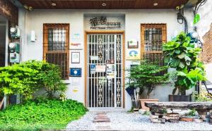 a front door of a house with a gate at Fuqi Hostel - Heping in Tainan