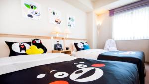 a bedroom with two beds with penguins on them at The New Hotel Kumamoto -DLIGHT LIFE & HOTELS- in Kumamoto