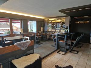 restauracja ze stołami i krzesłami oraz bar w obiekcie B&B La Montanara w mieście San Martino di Castrozza