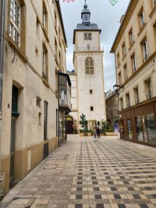 an empty street with a clock tower in a city at 101 Beffroi in Thionville