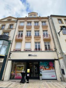a large building with a store in front of it at 101 Beffroi in Thionville