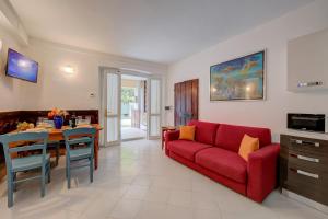a living room with a red couch and a table at Vicolo 42-private Terrace-200m Lake - Happy Rentals in Salò +18 photos