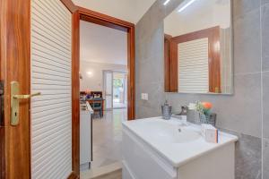 a bathroom with a white sink and a mirror at Vicolo 42-private Terrace-200m Lake - Happy Rentals in Salò
