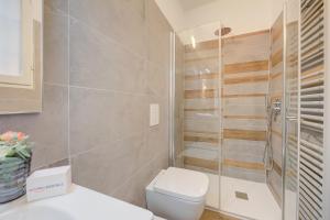 a bathroom with a toilet and a glass shower at Vicolo 42-private Terrace-200m Lake - Happy Rentals in Salò