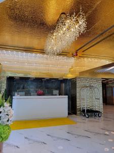 a lobby with a reception desk in a building at Grand Bay View Hotel in Hong Kong